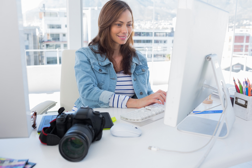 photo of a woman at a desk, with a camera