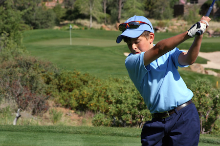 photo of a child playing golf