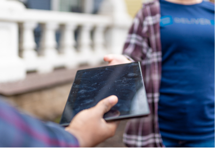 person handing child a tablet