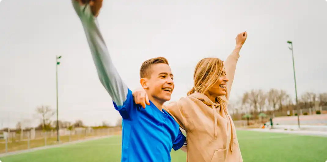 Photo of a mom and his son on a soccer field