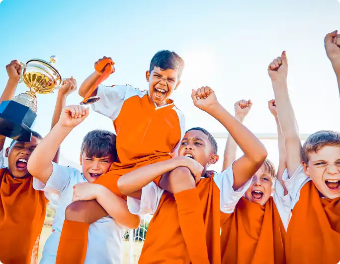 Photo of a happy youth soccer team celebrating a trophy